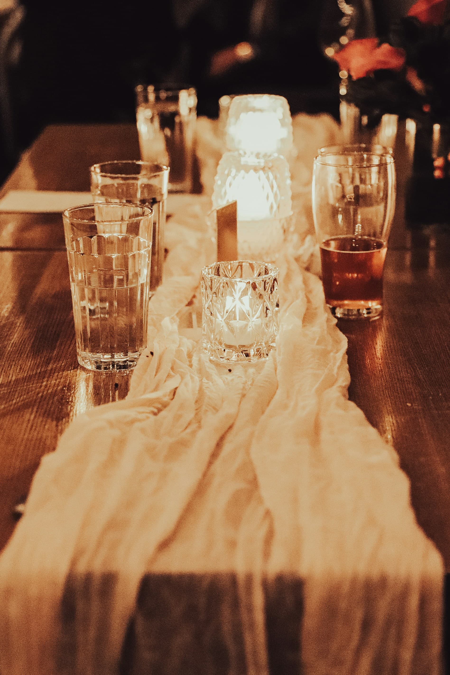 An after-dinner table with empty wine glasses and crumpled napkins.